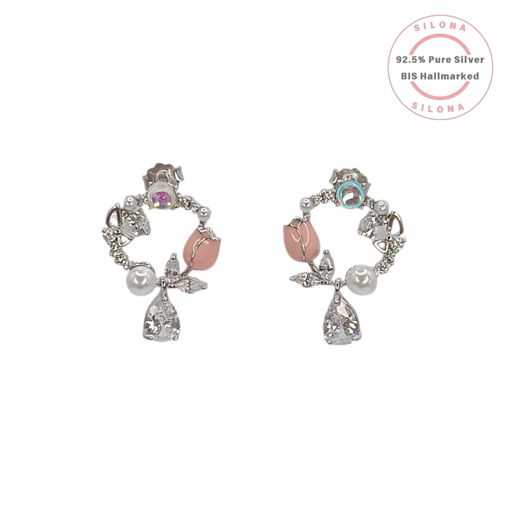 A pair of asymmetrical floral wreath stud earrings in 92.5 silver, featuring pink tulip buds, white pearls, and sparkling cubic zirconia stones.
