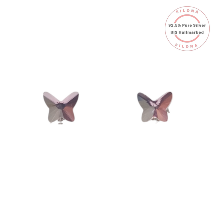 A pair of iridescent purple crystal butterfly stud earrings in 92.5 silver, shown on a white background with a Silona hallmark seal.