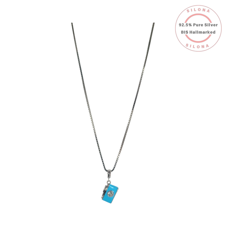 Silona Enamel Camera Charm Necklace with a turquoise pendant and cubic zirconia stone on a silver box chain, against a white background.