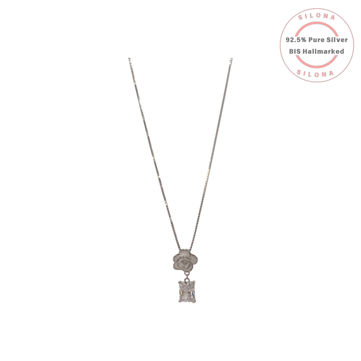 Silona's Chic Camellia Rose & CZ Drop Necklace in 92.5 silver, featuring a white enamel flower and a rectangular cubic zirconia on a box chain.