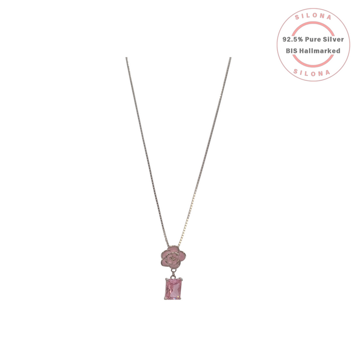 Silona silver necklace featuring a dusty pink enamel rose pendant with a dangling emerald-cut pink crystal on a white background.