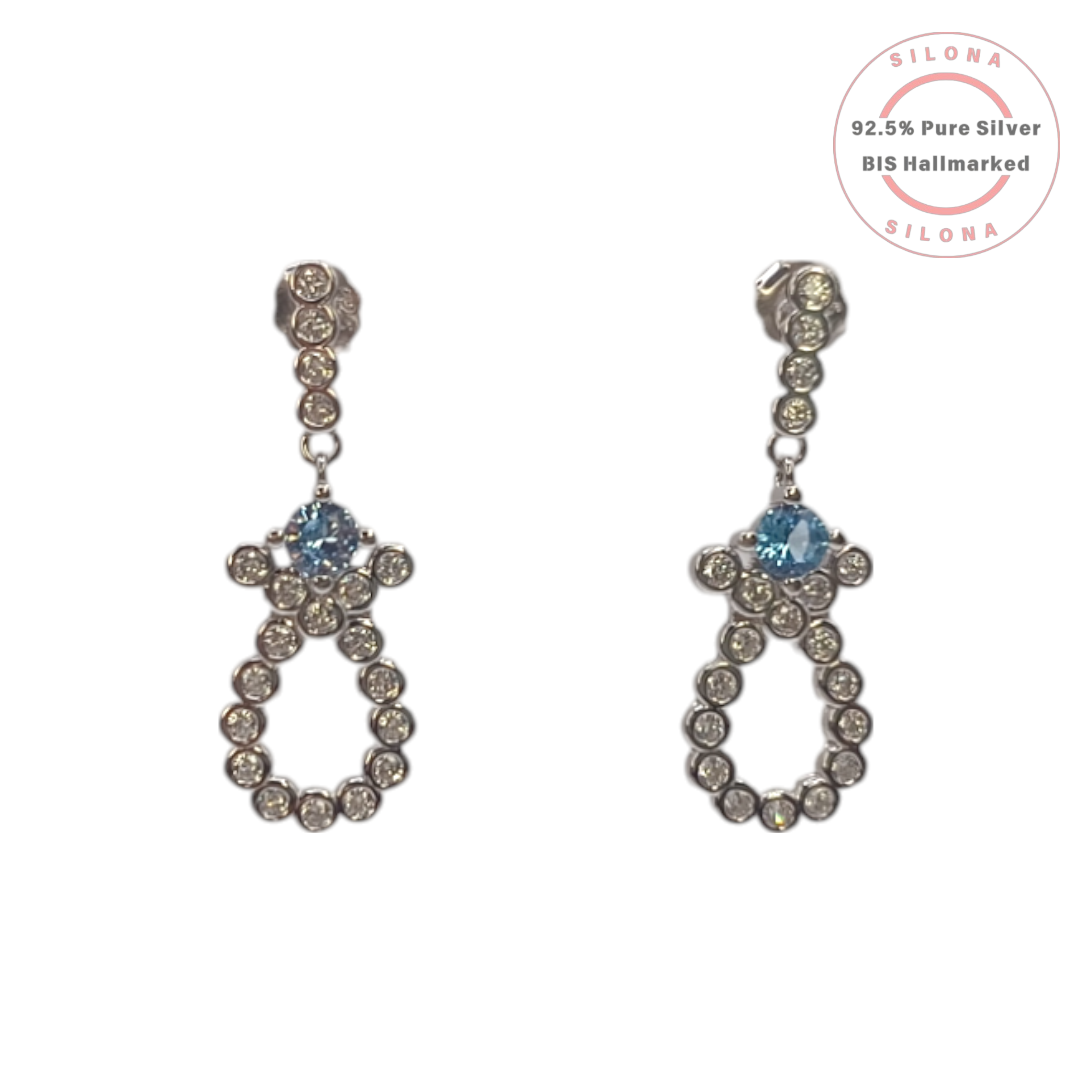 A pair of Silona silver drop earrings featuring a linear setting of white cubic zirconia, leading to an open loop motif set with more white CZ and a central light blue cubic zirconia stone, on a white background.