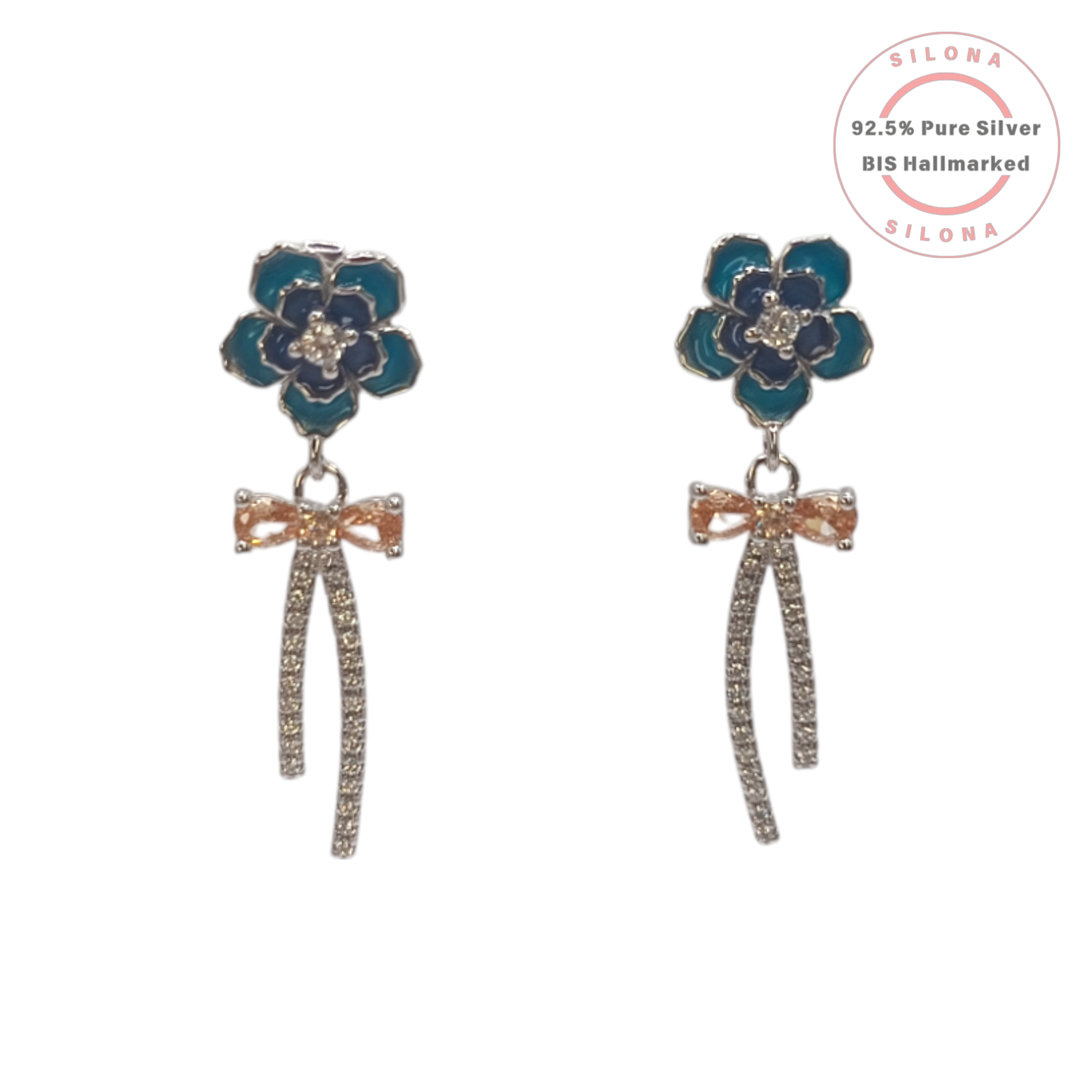 A pair of silver drop earrings featuring a blue enamel flower stud, a peach cubic zirconia bow, and dangling pavé-set streamers.
