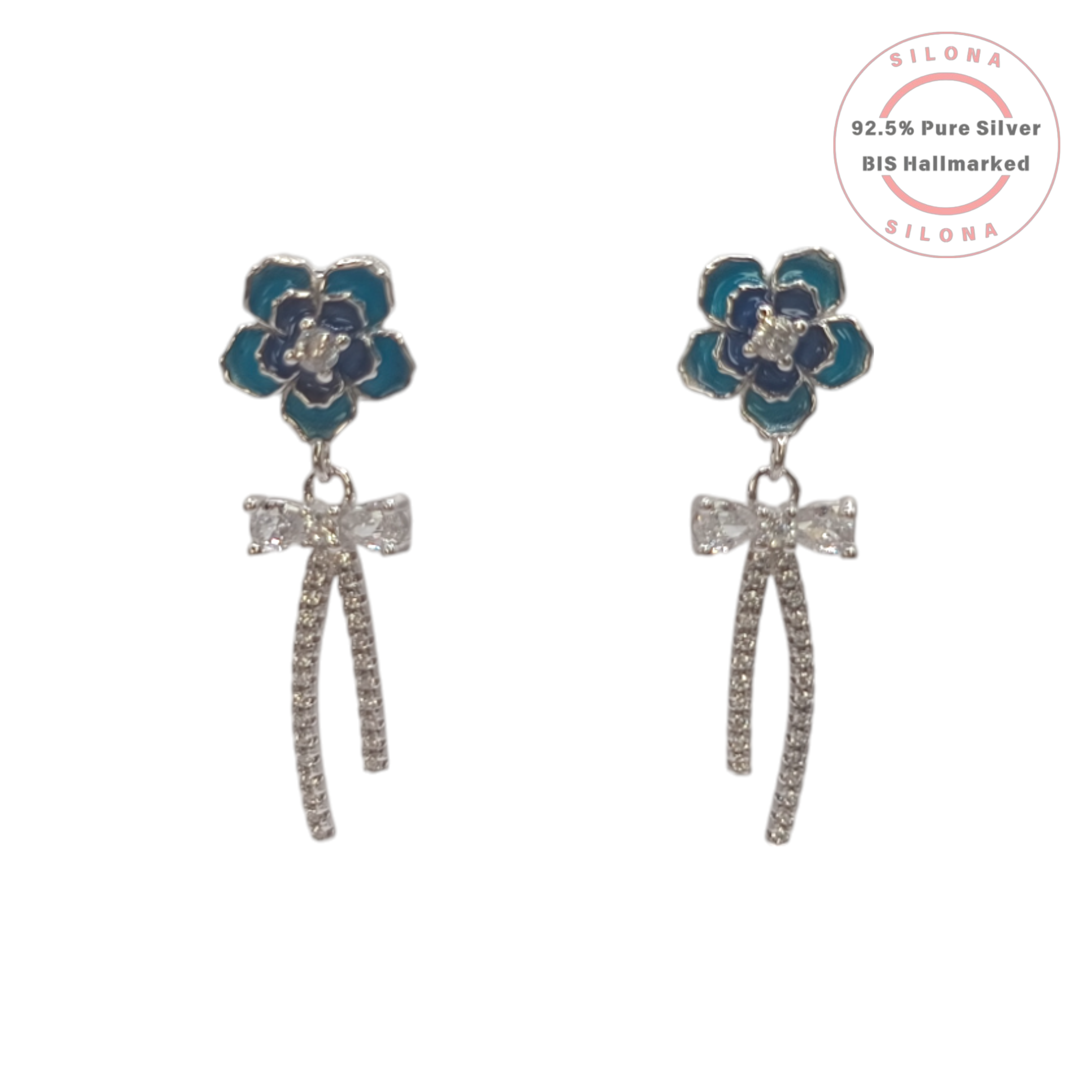 A pair of Silona's Azure Bloom & Bow Drop Earrings, featuring a blue enamel flower stud with a dangling pavé cubic zirconia bow, crafted in 92.5 sterling silver on a white background.