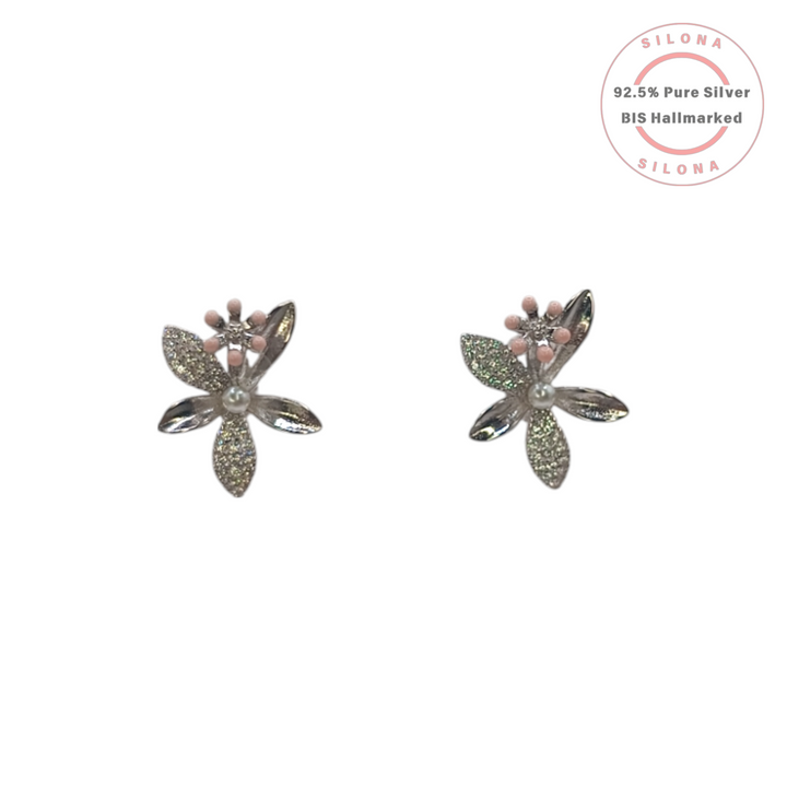 A pair of Silona Sakura Blossom Stud Earrings in 92.5 silver, featuring glittering pavé petals, a central pearl, and pink enamel details, shown on a white background.