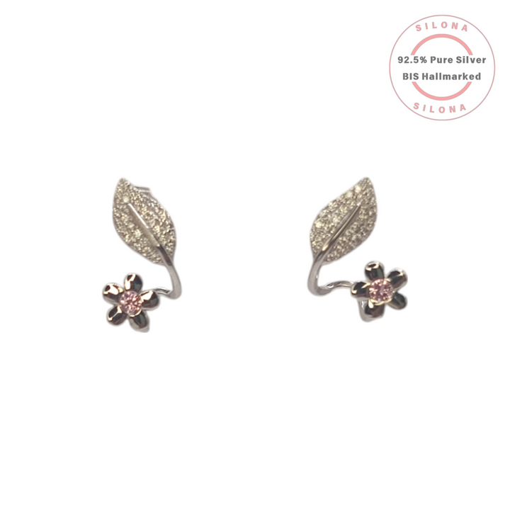 A pair of Silona's Floral Leaf & Pink Bloom Earrings in 92.5 silver, with a pavé leaf and a pink cubic zirconia flower.