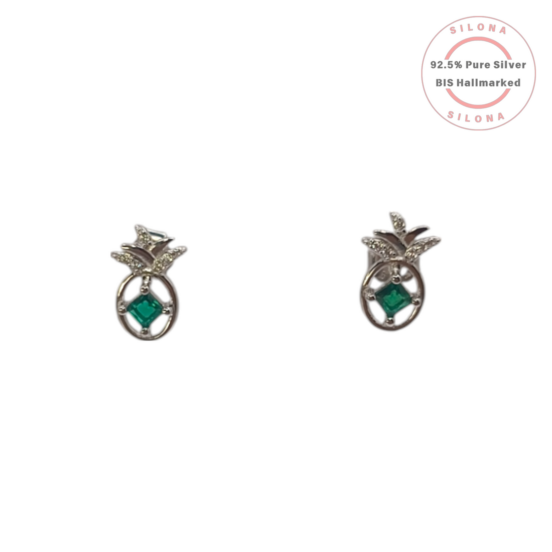 A pair of silver pineapple stud earrings, each with a central emerald-green square stone and sparkling cubic zirconia on the leaves, shown on a white background.