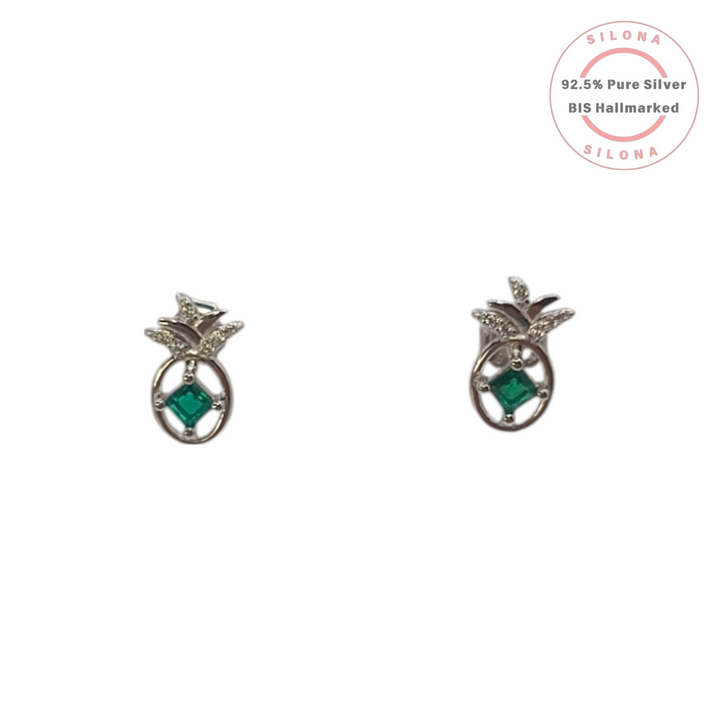 A pair of silver pineapple stud earrings, each with a central emerald-green square stone and sparkling cubic zirconia on the leaves, shown on a white background.