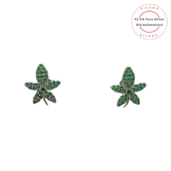 A pair of Silona's Emerald Hue Leaf Stud Earrings in 92.5 silver, pave-set with green cubic zirconia, on a white background.