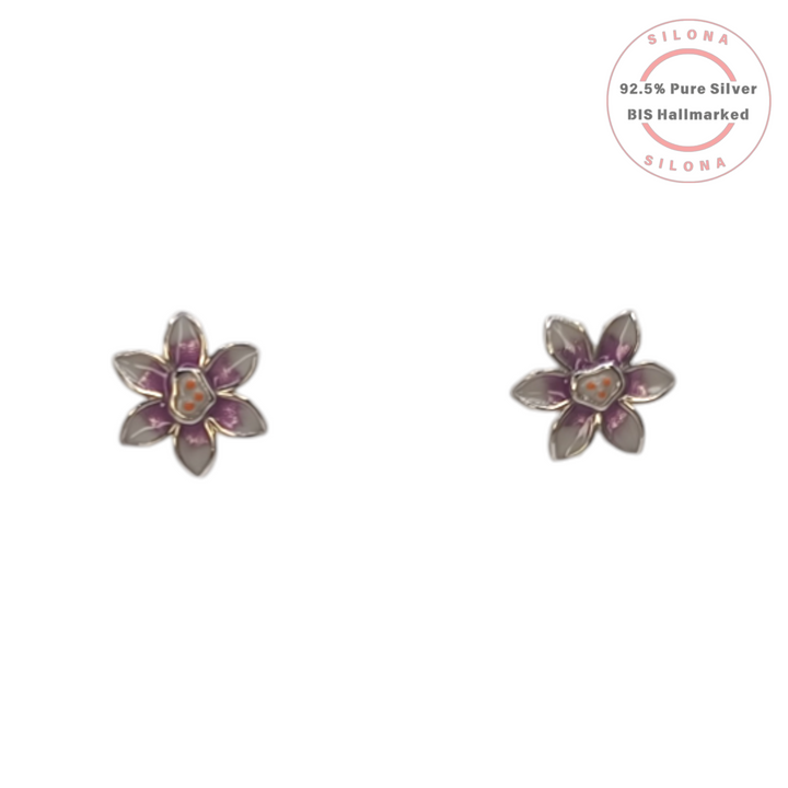 A pair of Silona's Lilac Enamel Blossom Stud Earrings in pure 92.5 silver, featuring a six-petal floral design with purple and orange details, on a white background.