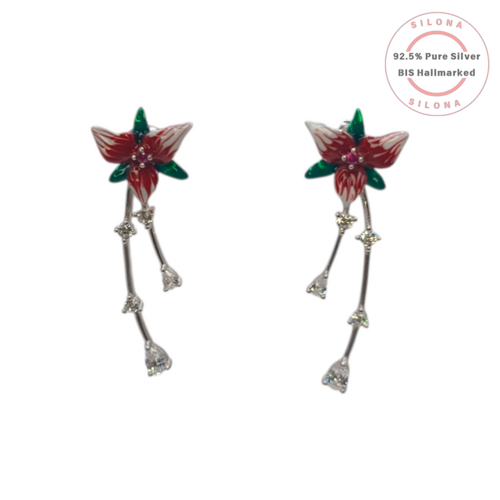 A pair of Silona Crimson Lily Drop Earrings in 92.5 silver, featuring red and white enamel flowers with dangling cubic zirconia strands on a white background.