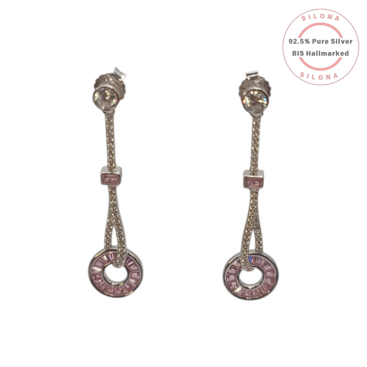 A pair of Art Deco style silver drop earrings featuring brilliant-cut clear and baguette-cut rose pink cubic zirconia stones, on a white background.