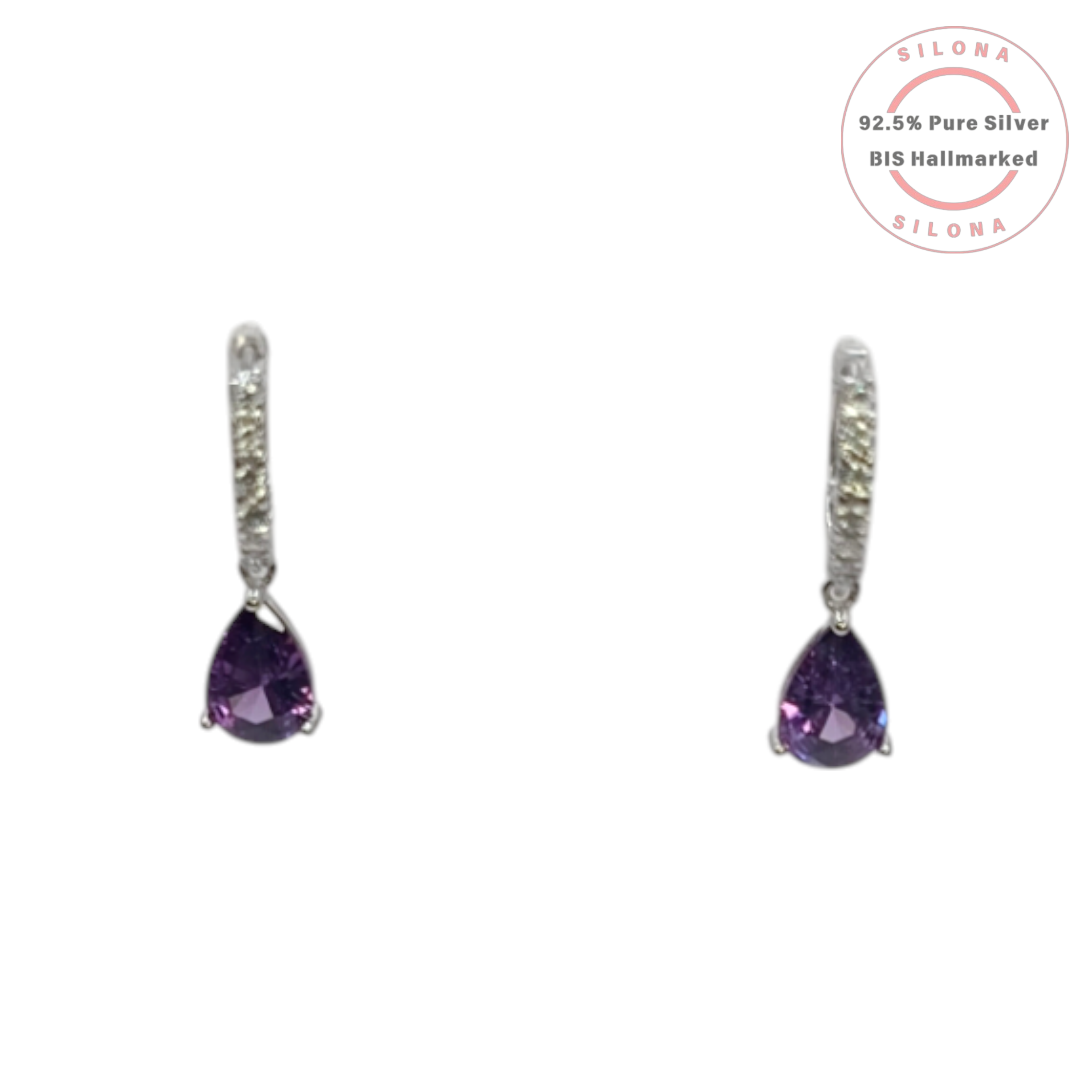 A pair of Silona silver huggie earrings with paved cubic zirconia and a dangling pear-shaped amethyst-purple stone on a white background.