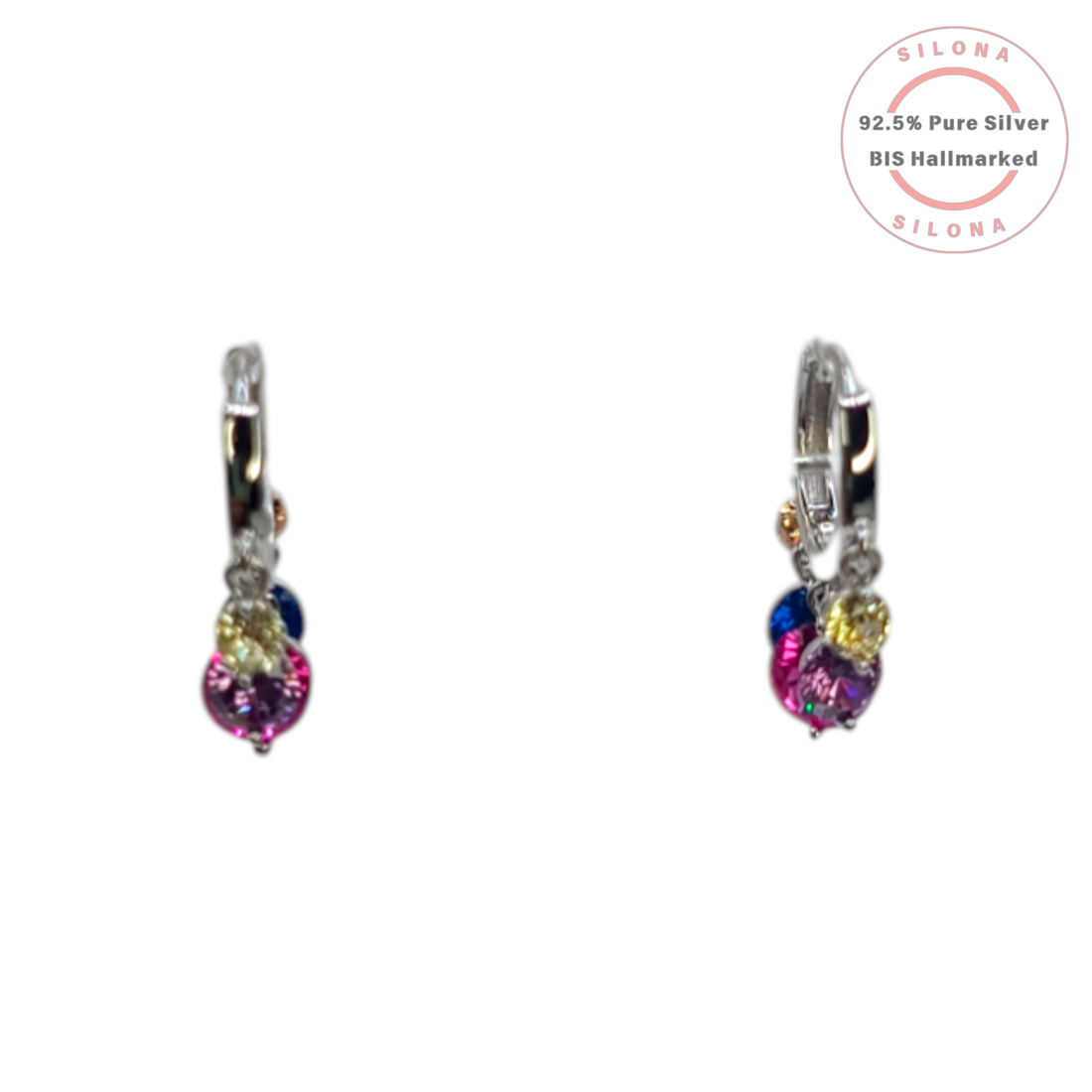 A pair of Silona silver huggie hoop earrings with a dangling cluster of colorful pink, blue, and yellow cubic zirconia stones on a white background.