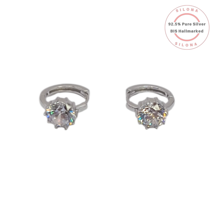 A pair of Classic Solitaire Huggie Earrings in 92.5 silver, featuring brilliant round-cut cubic zirconia stones on a white background.