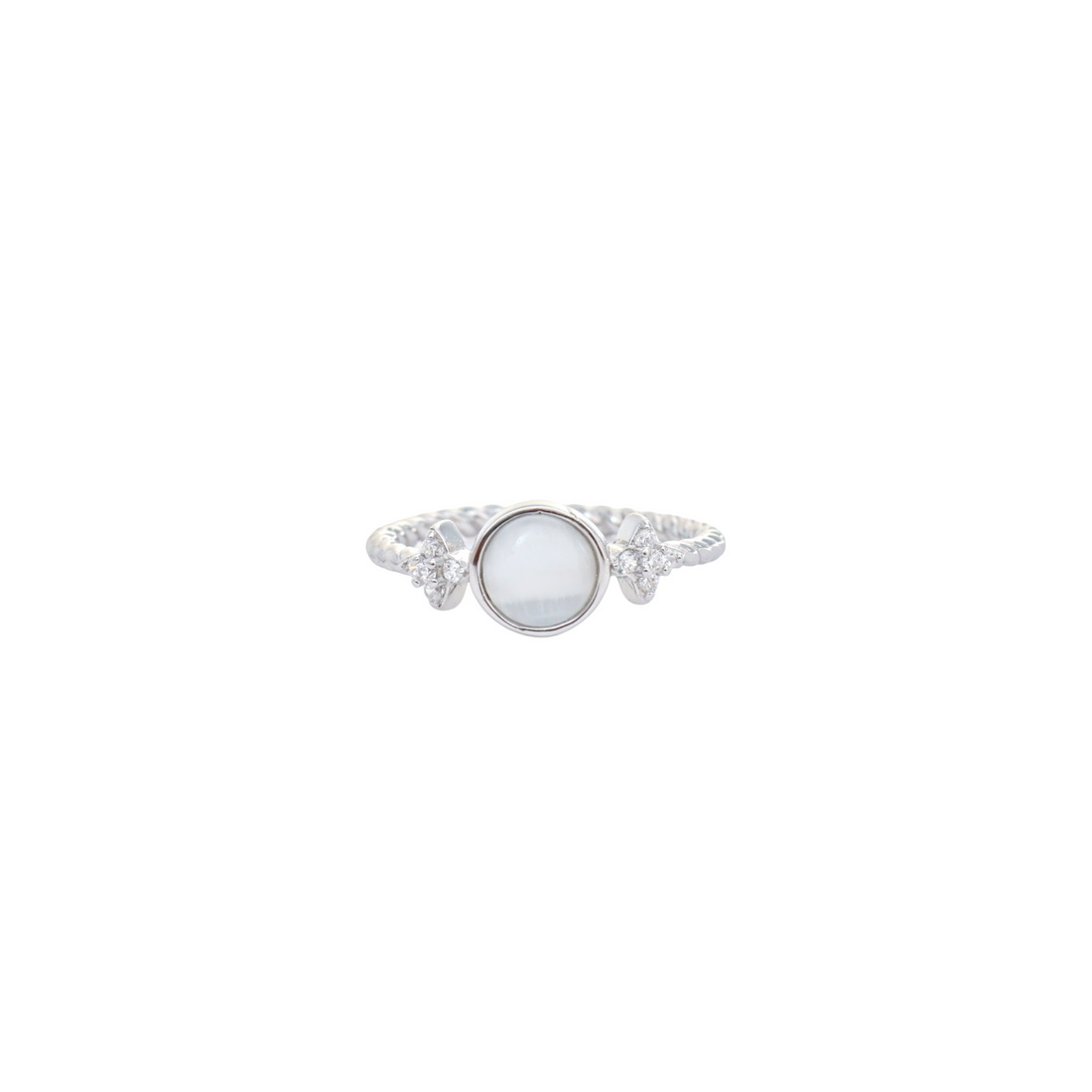 Round milky white stone cabochon set on a twisted silver band with star side accents.