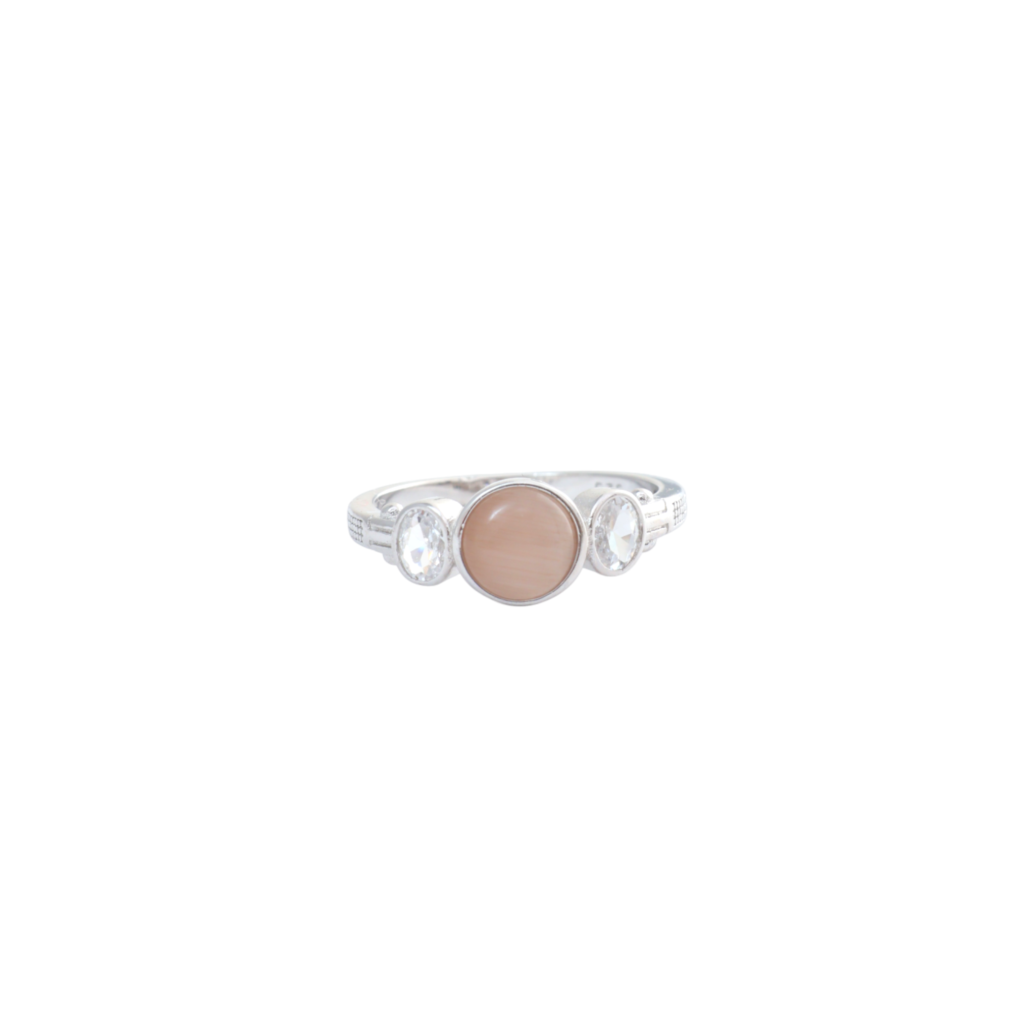 Round peach-colored smooth cabochon flanked by oval clear gems set in silver bezels.