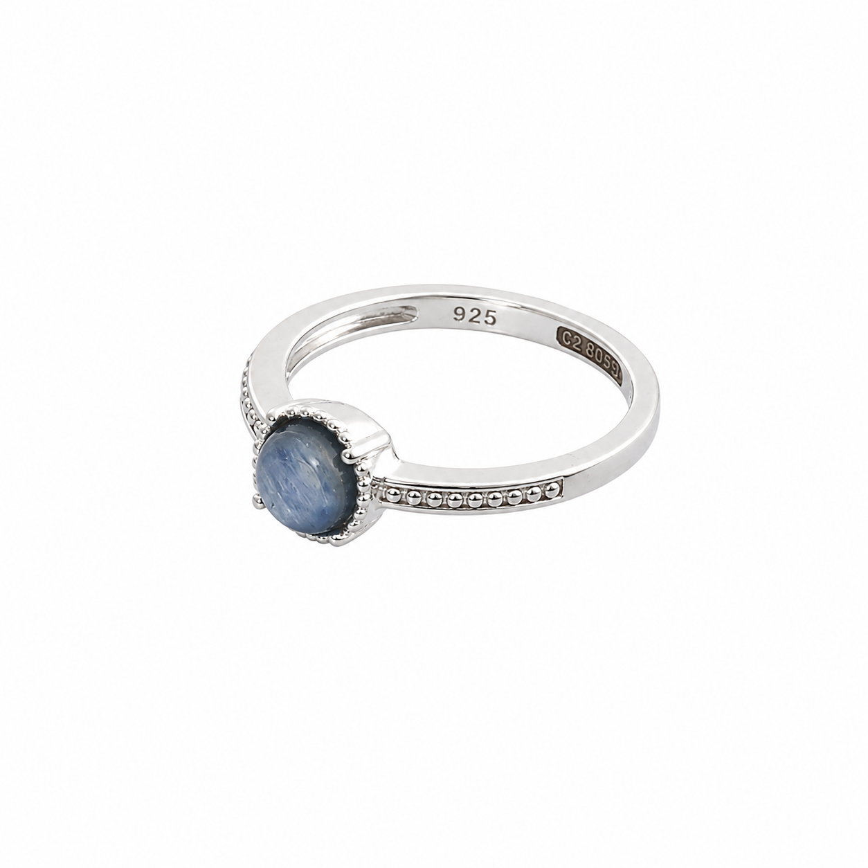 Round blue kyanite stone with chatoyant sheen encircled by a beaded silver halo on a thin band.