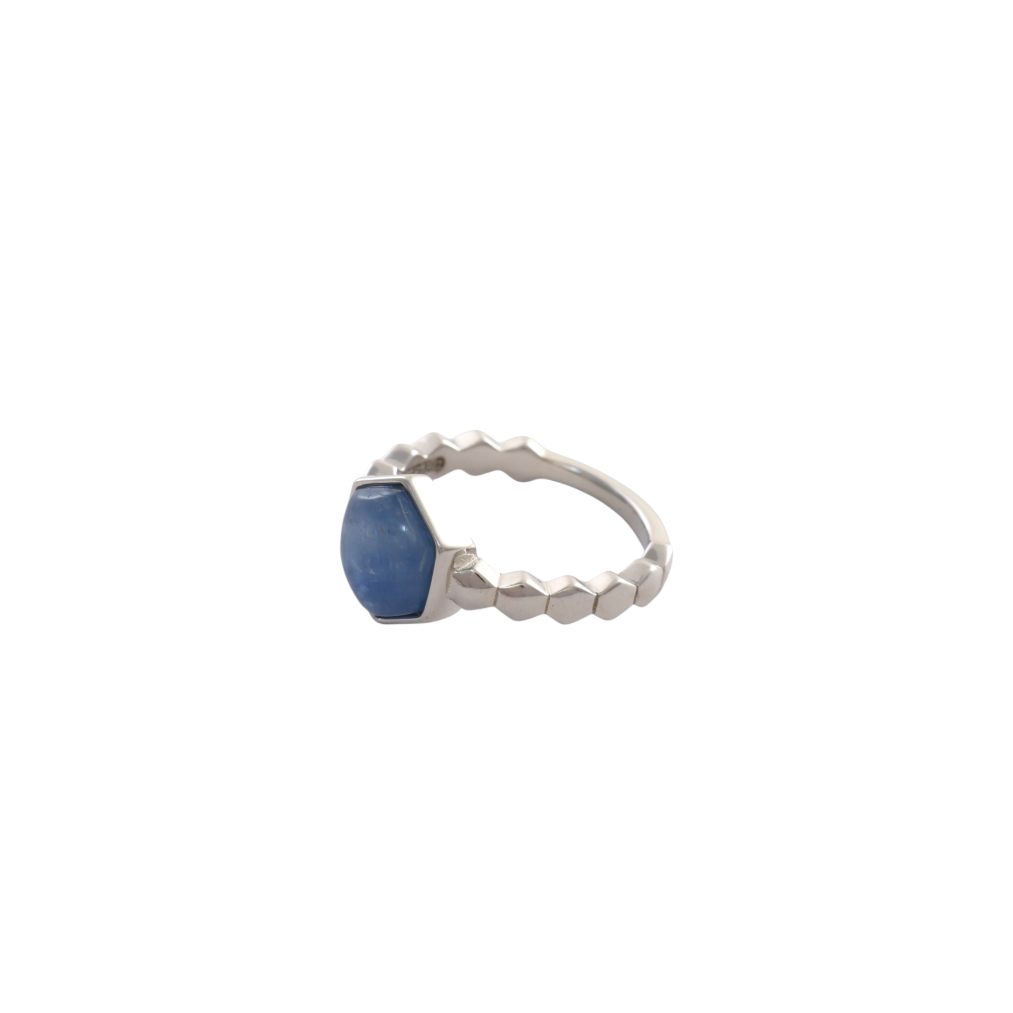 Hexagonal blue kyanite stone mounted in a bezel setting on a faceted silver ring.