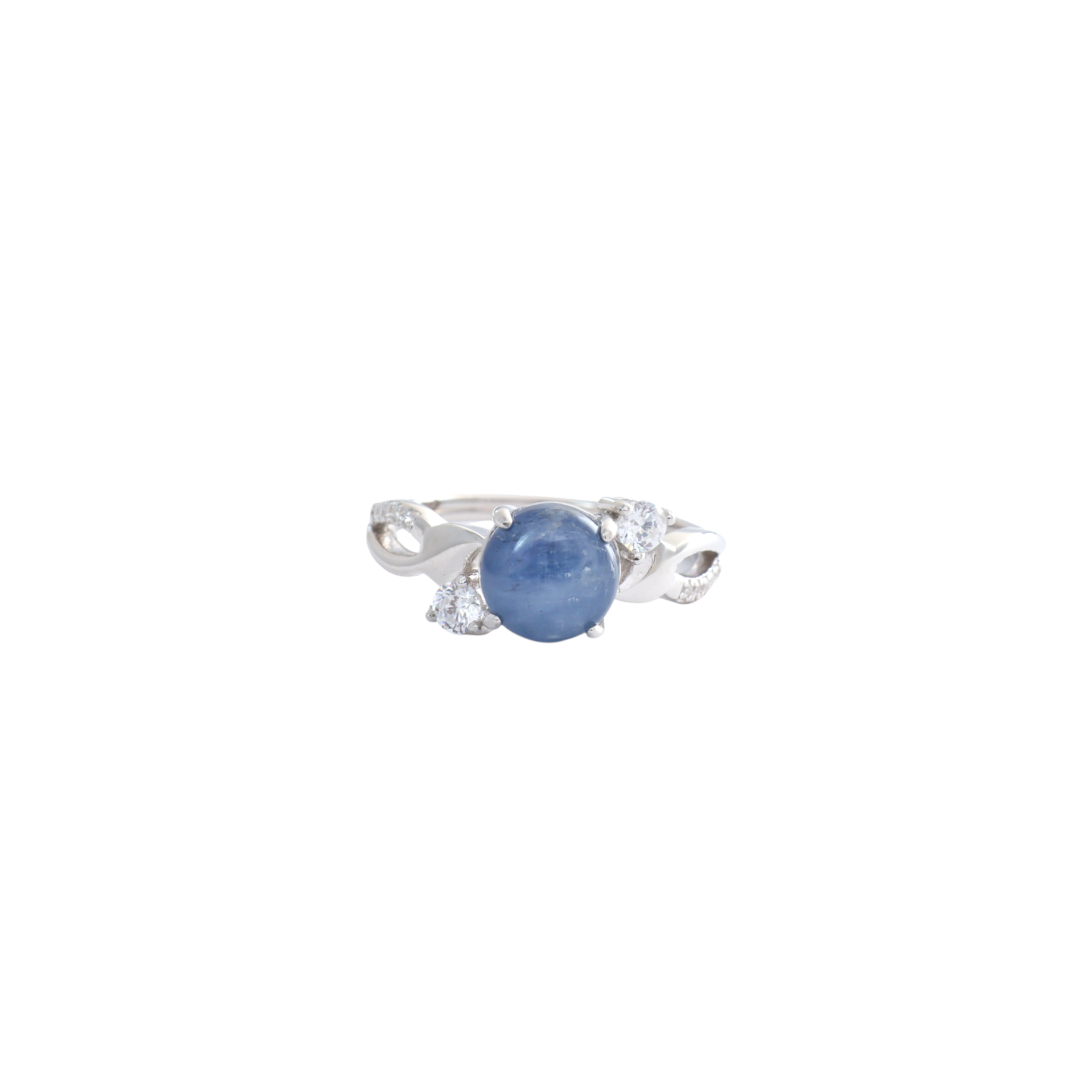 Round kyanite blue cabochon nestled between sweeping pave cz bypass arms in silver.