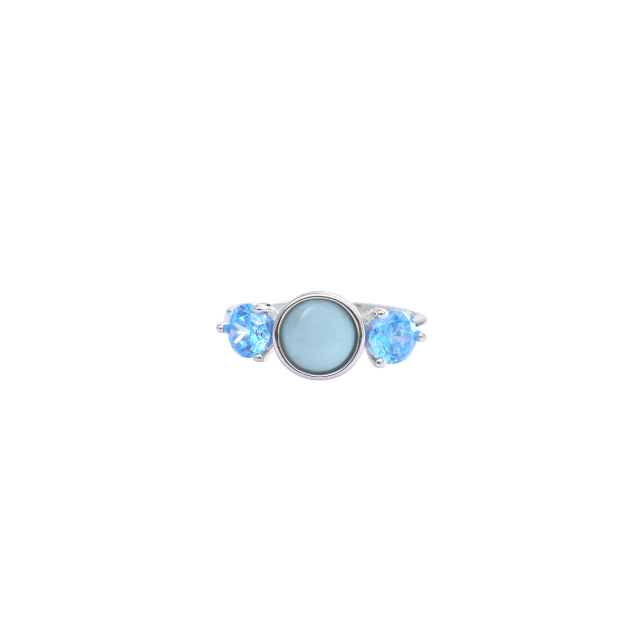 Round sky blue cabochon flanked by two faceted electric blue gems on a polished silver ring.