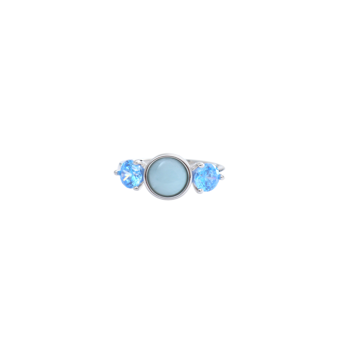 Round sky blue cabochon flanked by two faceted electric blue gems on a polished silver ring.