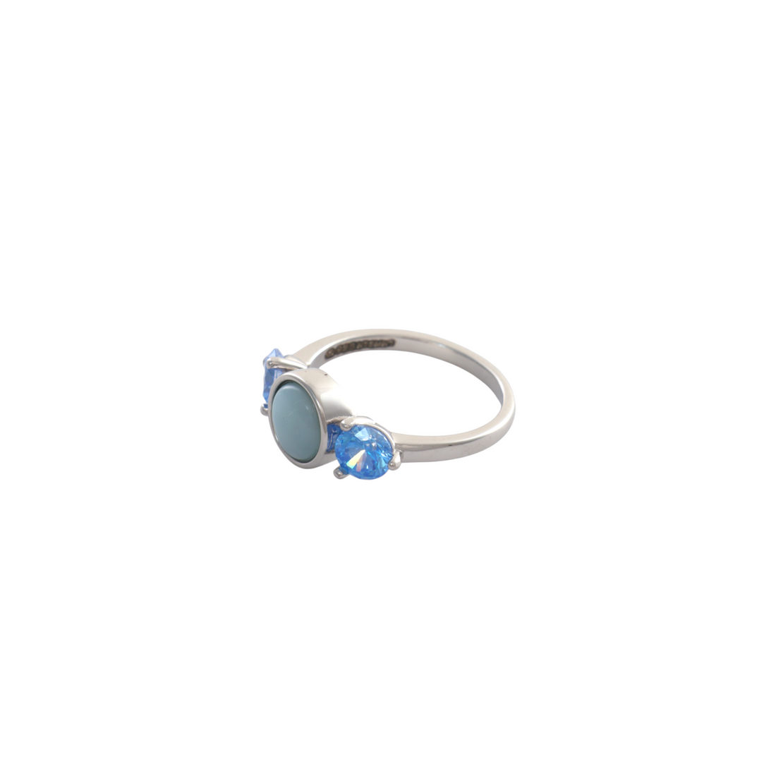 Round sky blue cabochon flanked by two faceted electric blue gems on a polished silver ring.