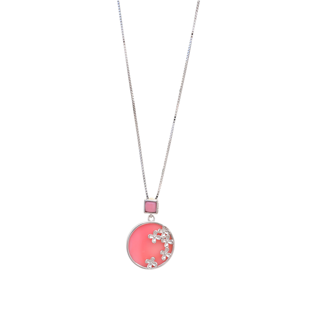 Silver chain necklace holding a round pink disc pendant embellished with tiny silver flower blossoms.