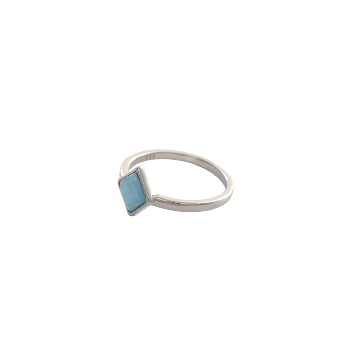 Diamond-shaped light blue larimar cabochon stone in a bezel setting on a simple silver band.