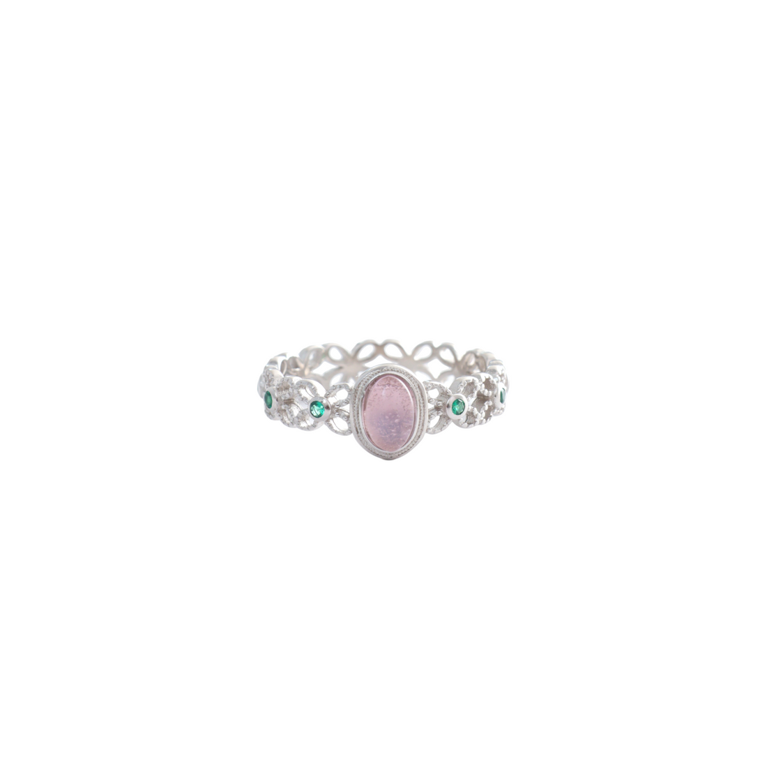 Pink oval center stone on an intricate filigree lace silver band studded with green accents.