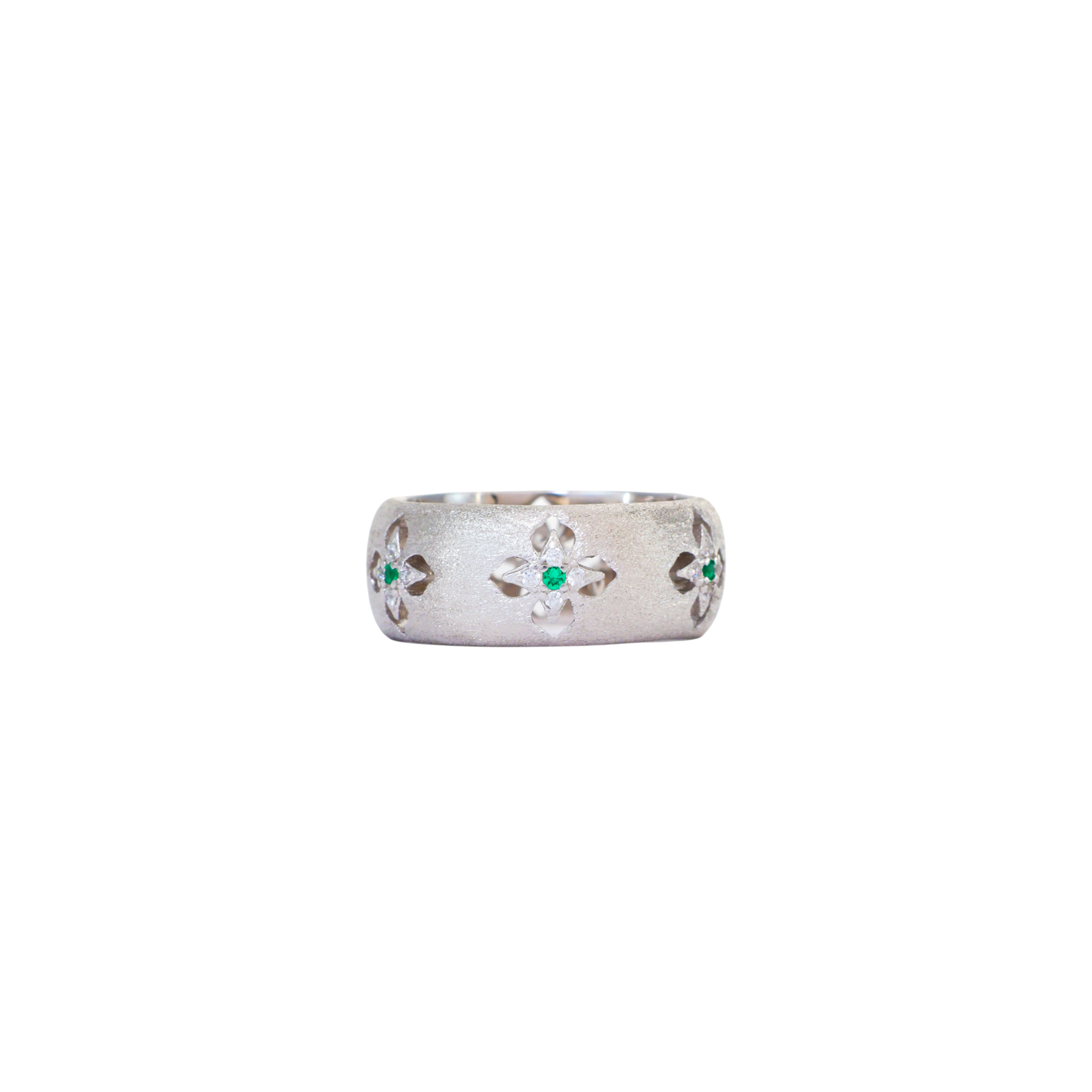 Wide satin brushed silver ring featuring carved starburst cutouts with green accent stones.