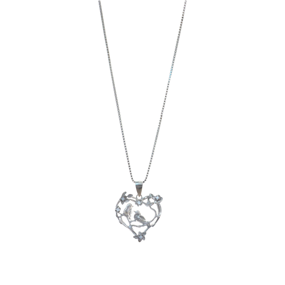 Silver chain necklace holding an openwork heart pendant with two lovebirds sitting on a floral branch.