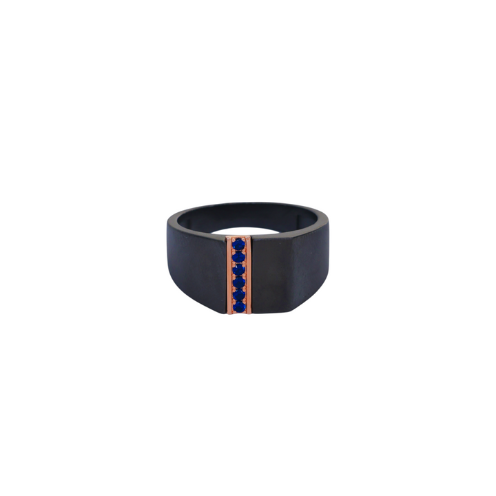 Matte black ruthenium ring featuring a vertical rose gold bar set with five blue round gems.