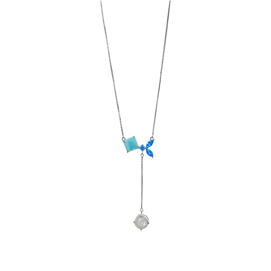 A silver-tone lariat necklace styled with square blue gems, marquise crystals, and a suspended white orb charm.