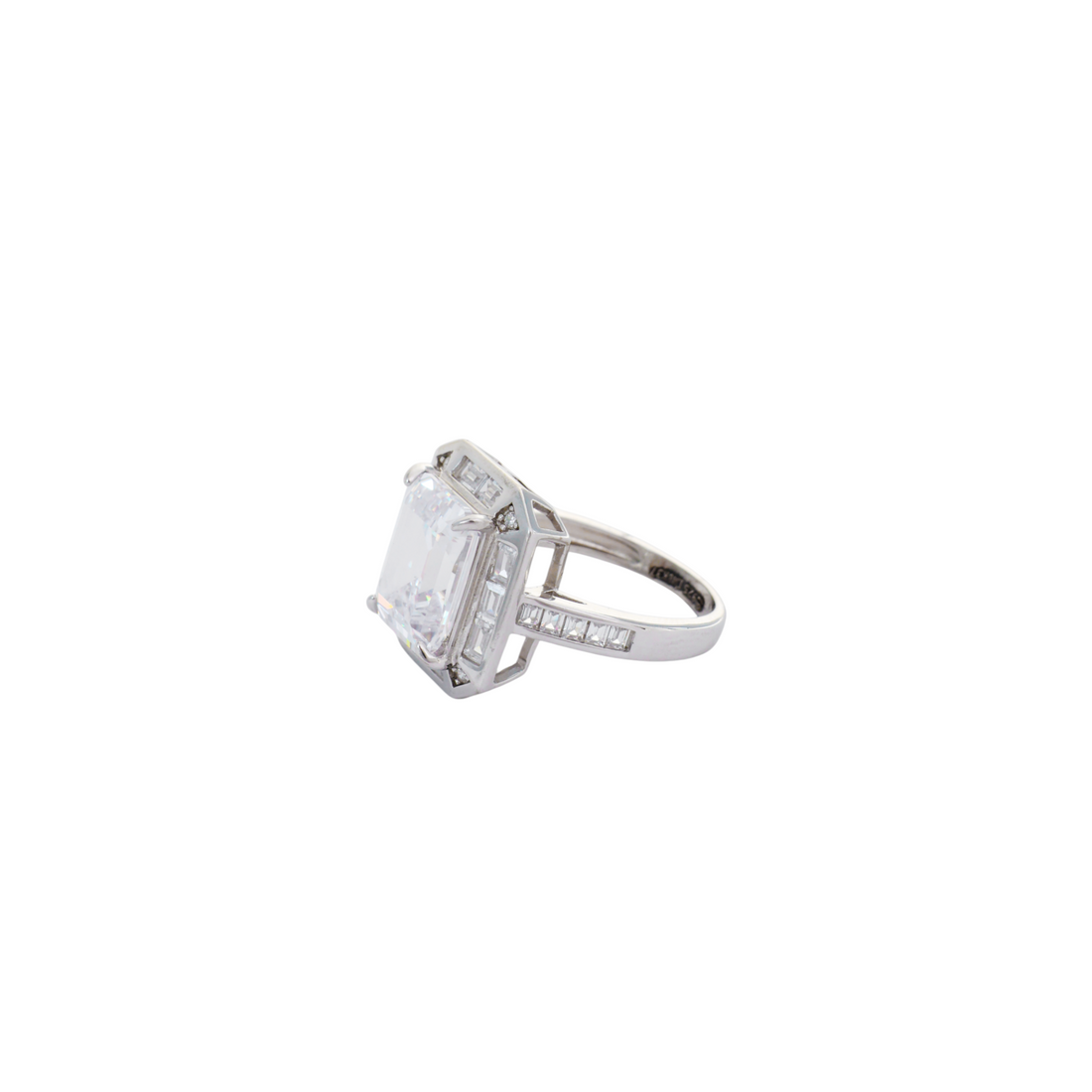 Large clear emerald-cut gemstone surrounded by a baguette crystal halo on a channel-set band.