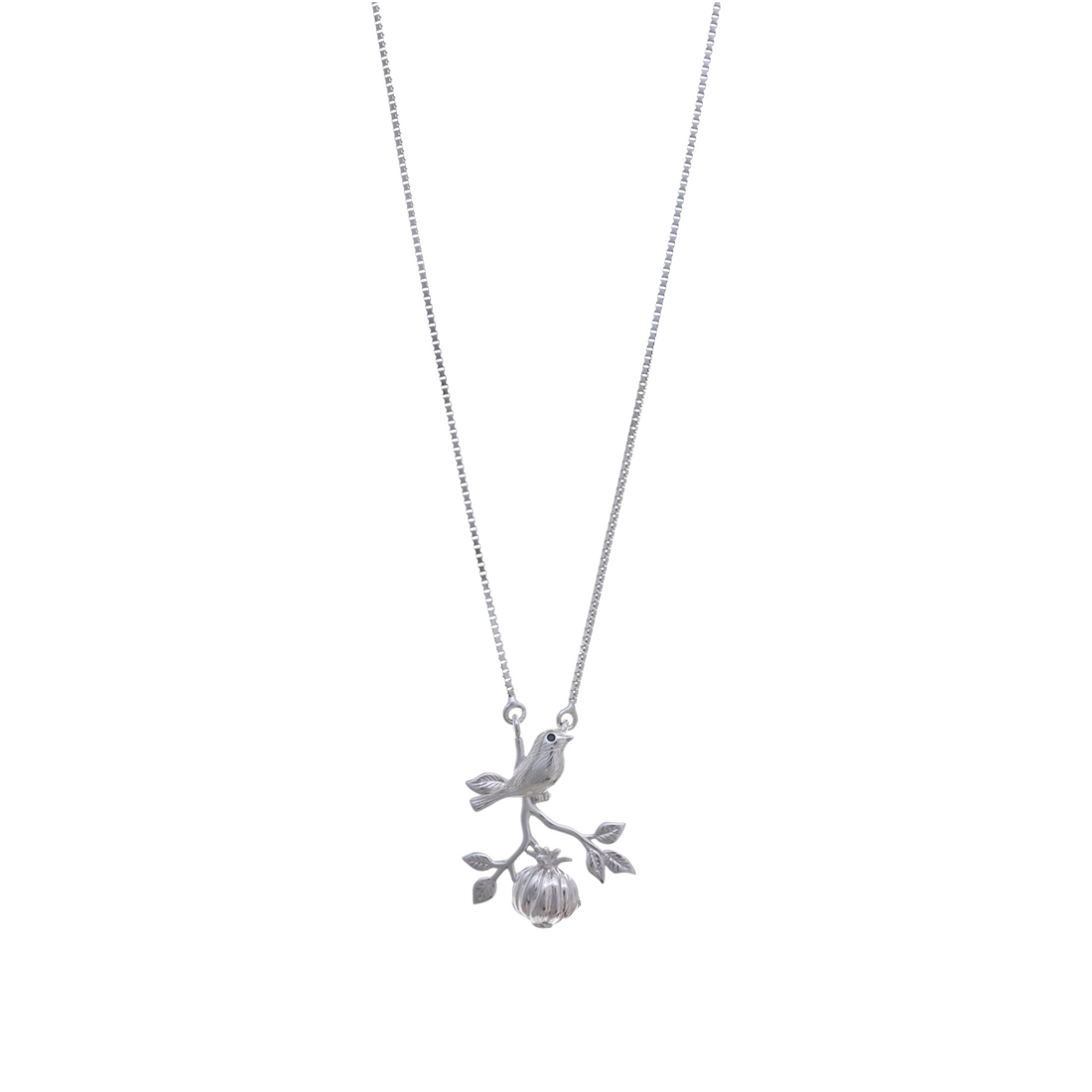 A silver box chain holding a pendant of a detailed bird perched on a branch with leaves and hanging fruit.