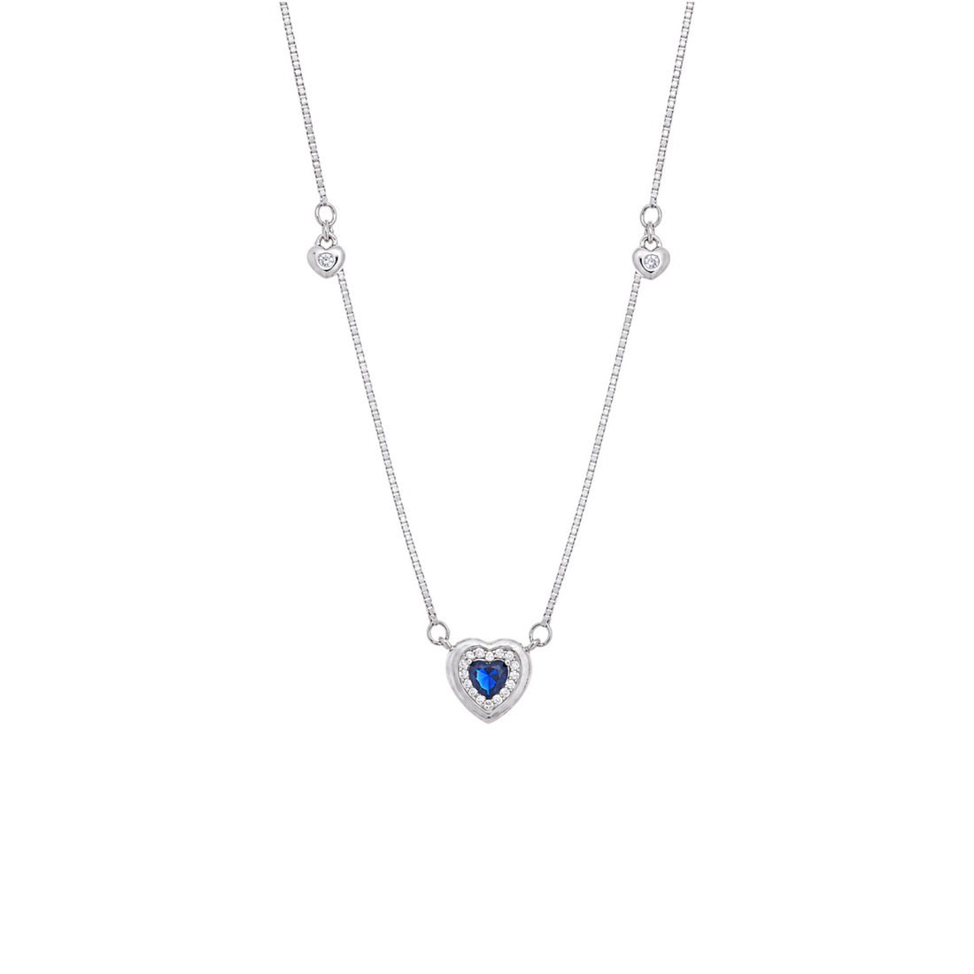 A silver station chain featuring a heart-shaped blue gemstone pendant enclosed in a halo of clear crystals.