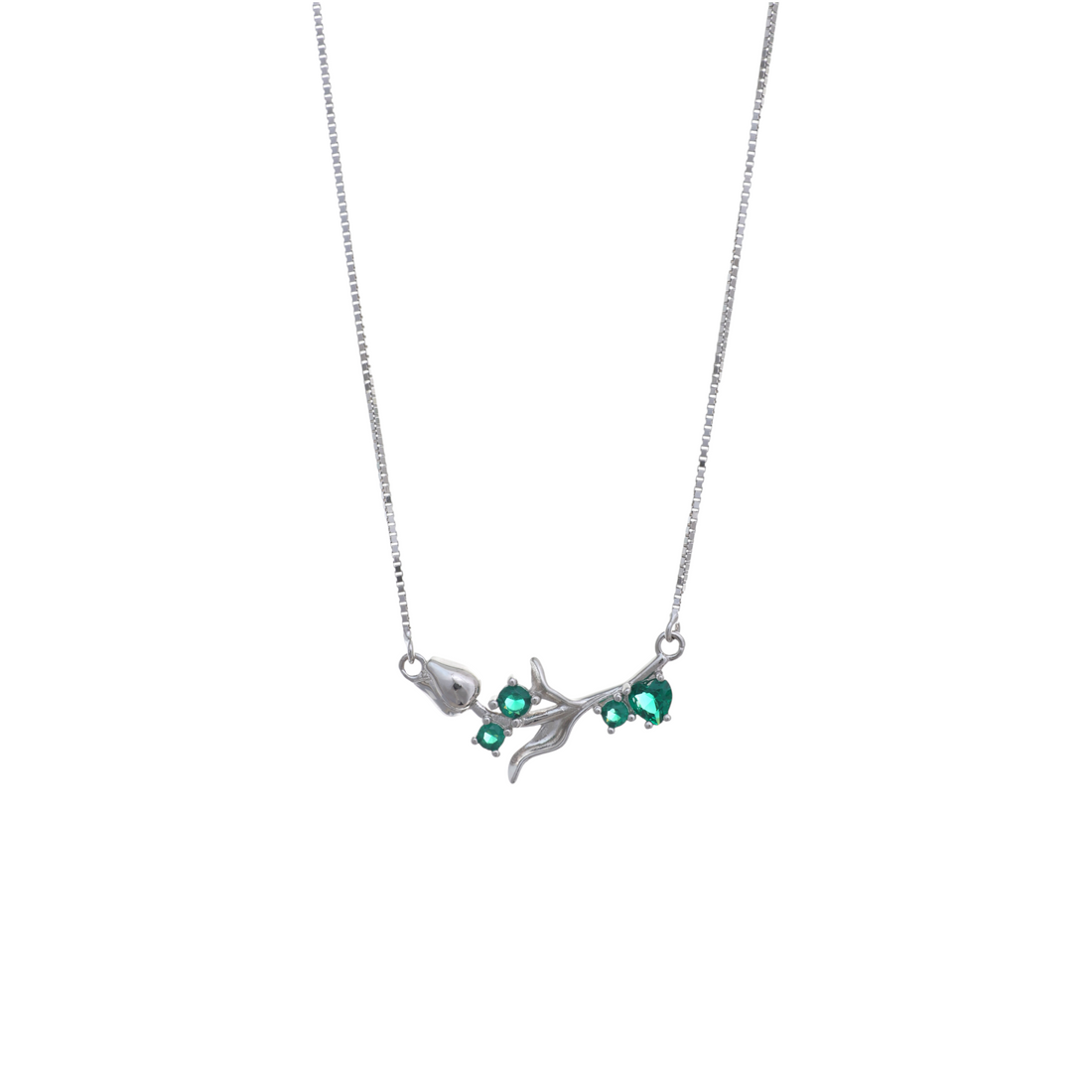A silver box chain necklace with a horizontal floral branch pendant accented with bright green gemstones.