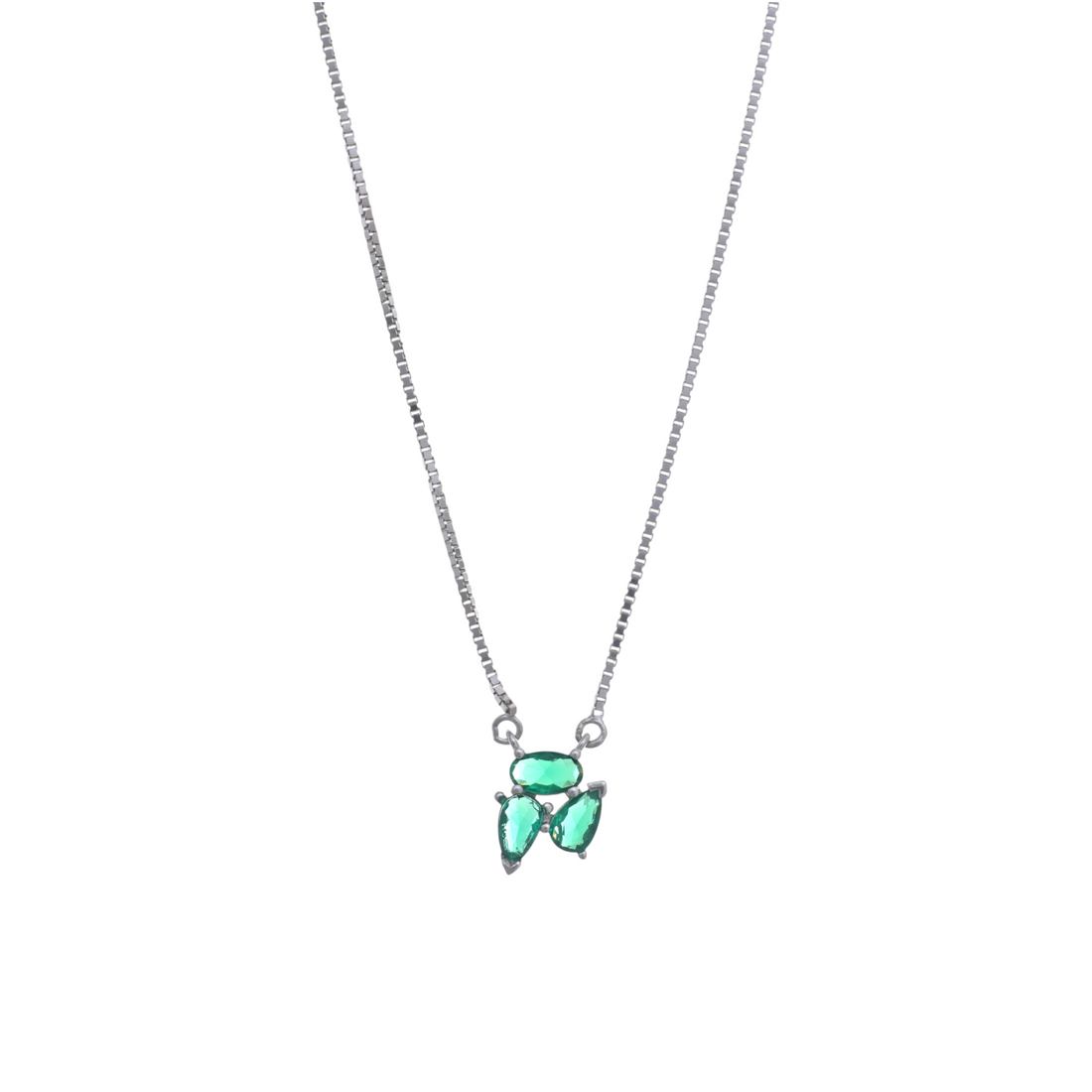 A silver chain necklace displaying a trio cluster pendant made of bright green cut gemstones.